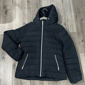 Women’s black puffer jacket with silver hardware